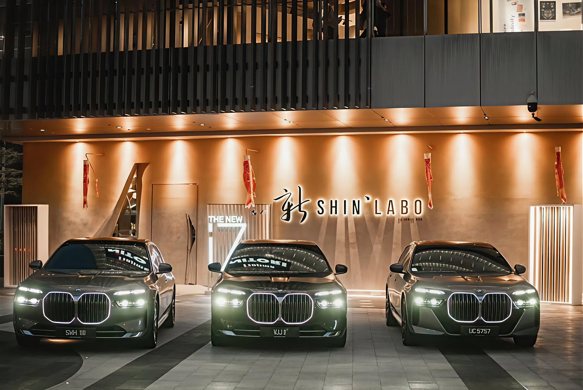 Three BMW i7s with illuminated grilles outside Shin'Labo, Lalaport, Kuala Lumpur