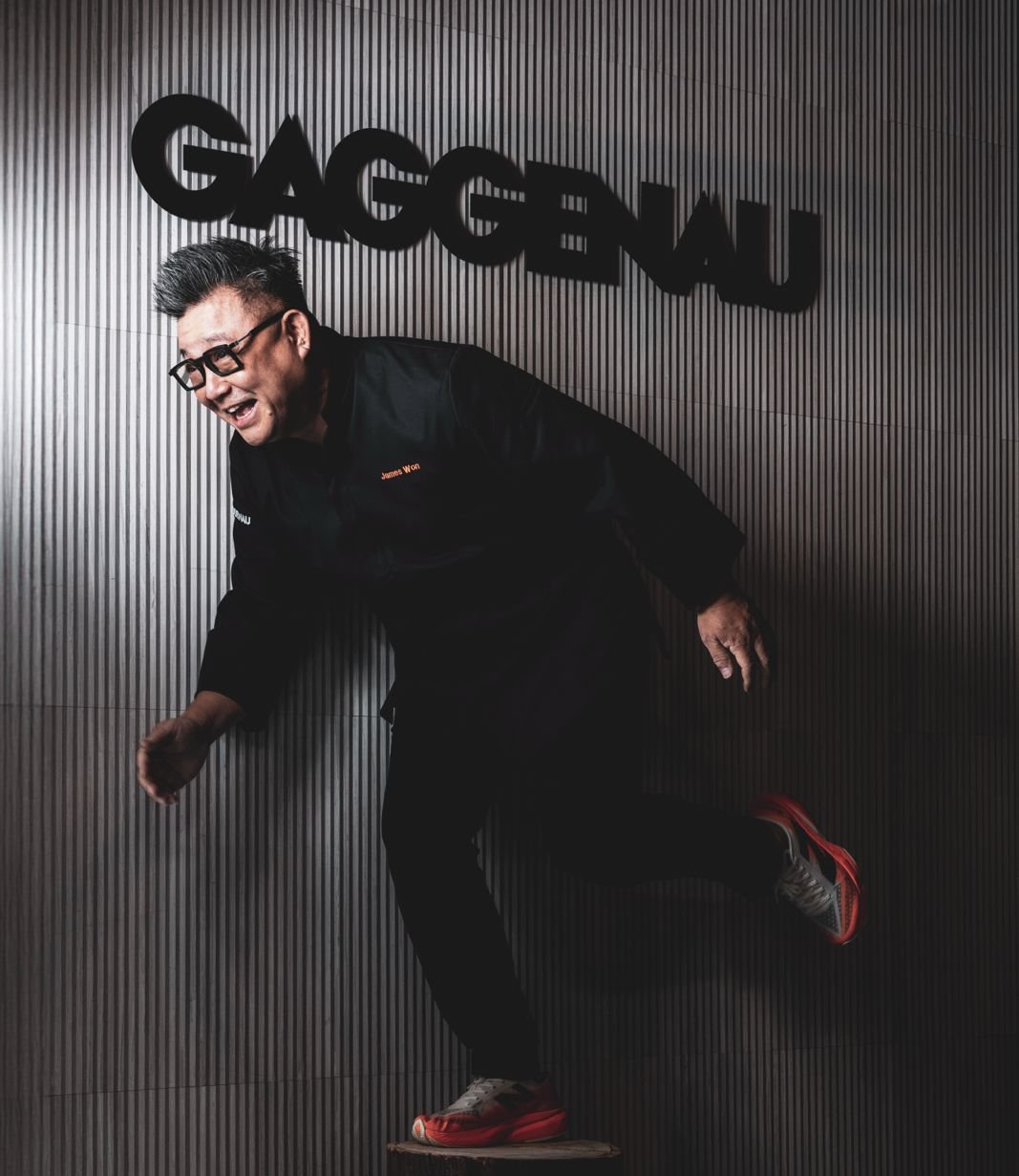 James Won mid-stride beneath the GAGGENAU sign &mdash; an action frame from the Inspiration Haus shoot.