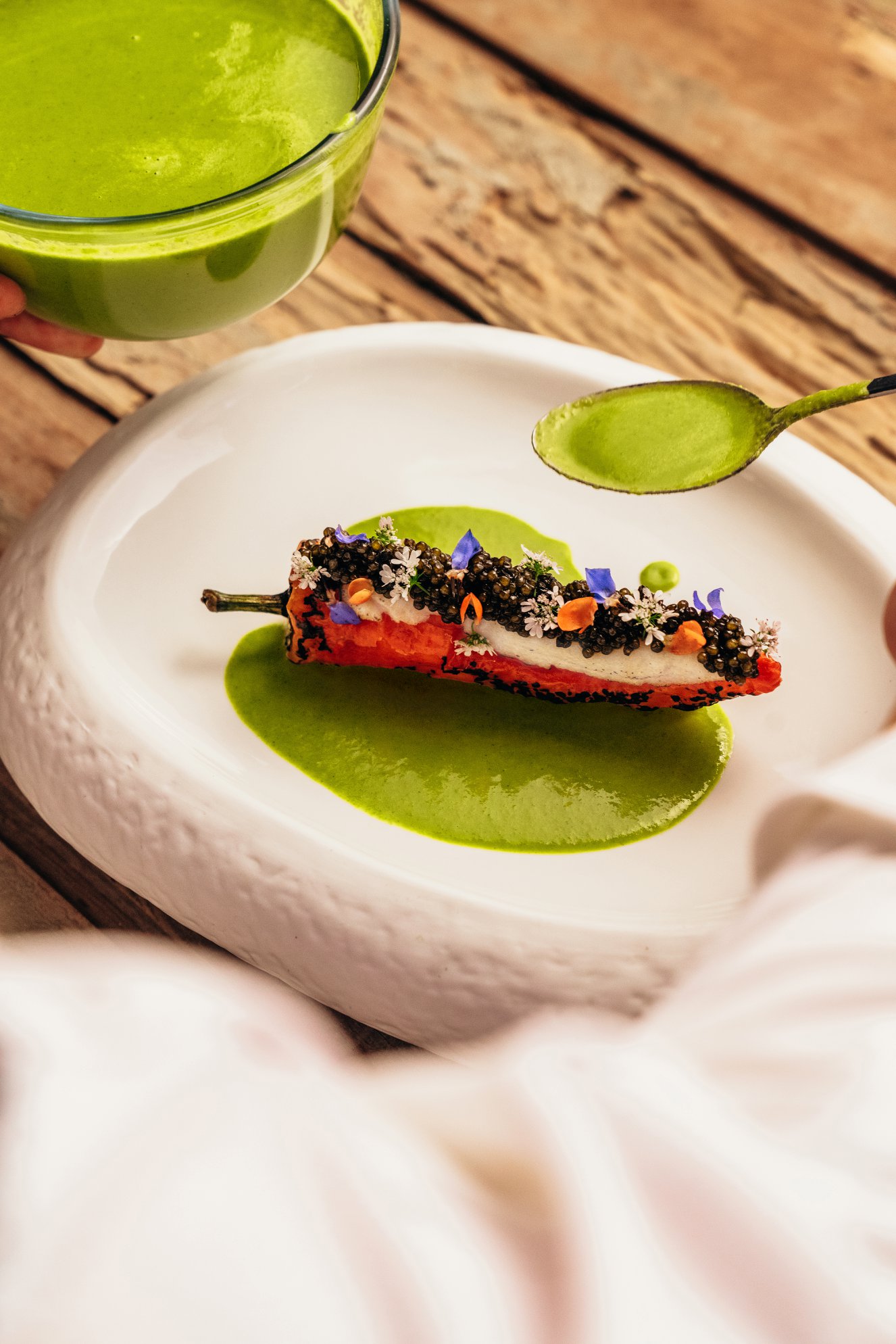 Krug × Pepper: a red pepper filled as Hakka yong tau foo, finished with caviar and flowers on a green sauce.