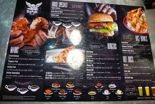 The BadBoyCooks Diner placemat menu: house specials, mains, burgers, rice bowls and hot dogs on a black chalkboard-style sheet.
