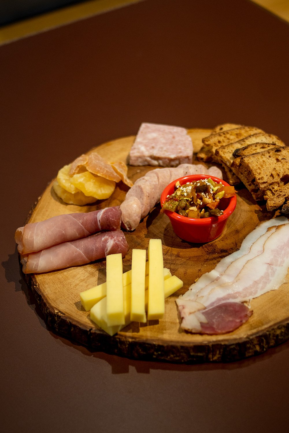 Bouchon Enfin charcuterie spread — cured pork, smoked bacon, cheese, dried fruit, sourdough.