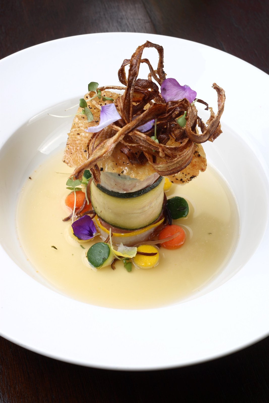Duck rillettes with foie tower, crispy burdock, Parisienne roots, duck consommé.
