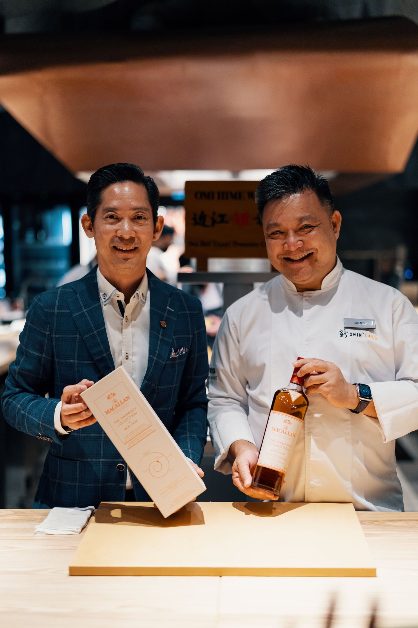 James Won in whites and a guest at the Shin'Labo counter, opening a bottle of The Macallan.