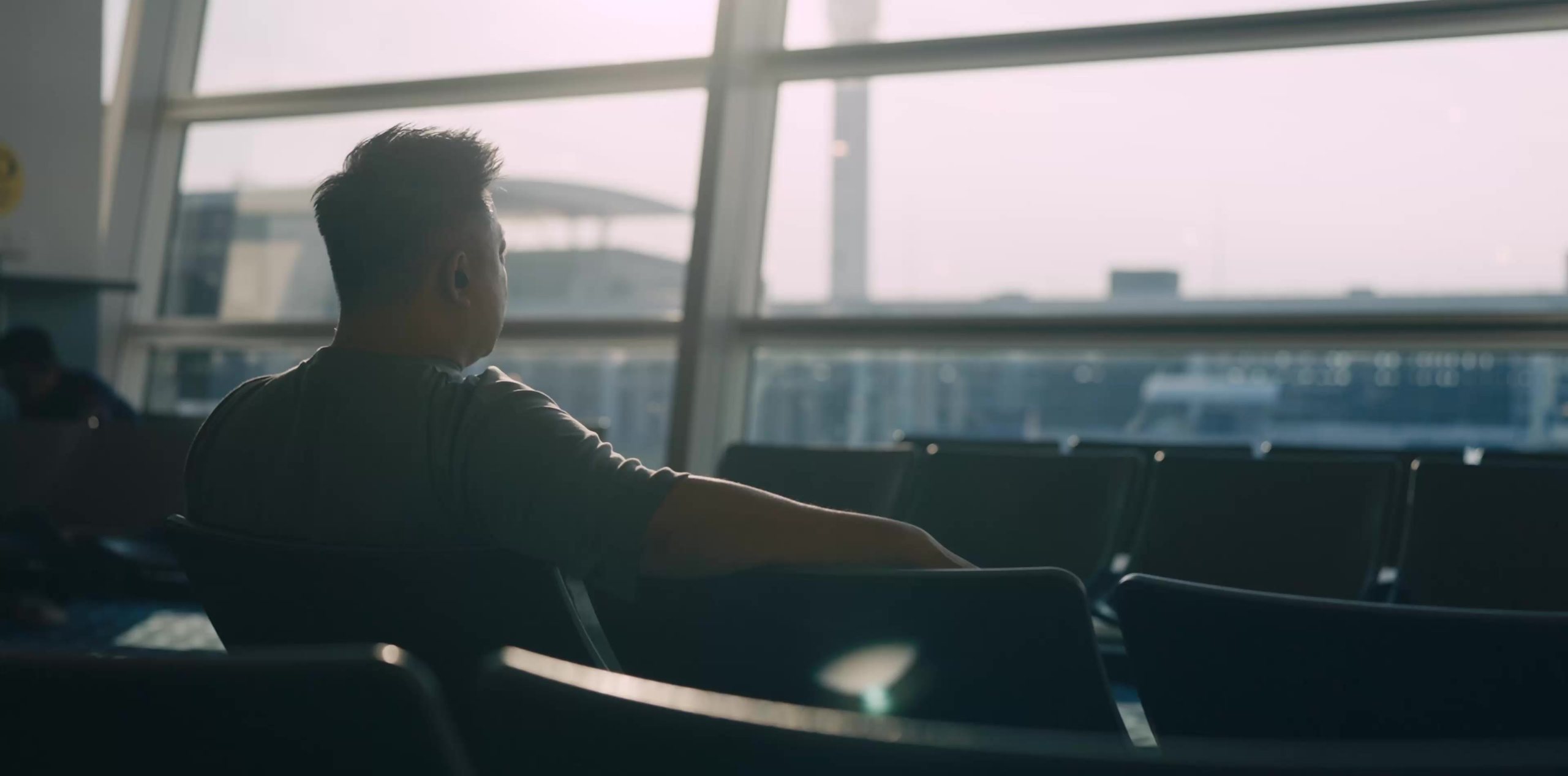 Looking out over the runway from an airport departure lounge, a still from the documentary made for Osaka