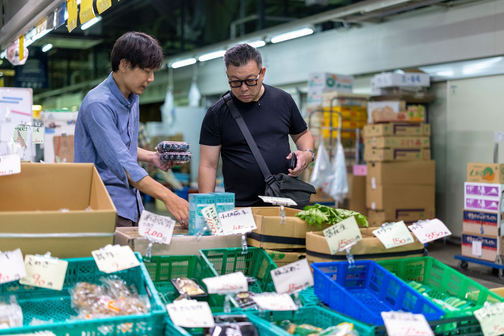 Looking over greens at an Osaka market stall