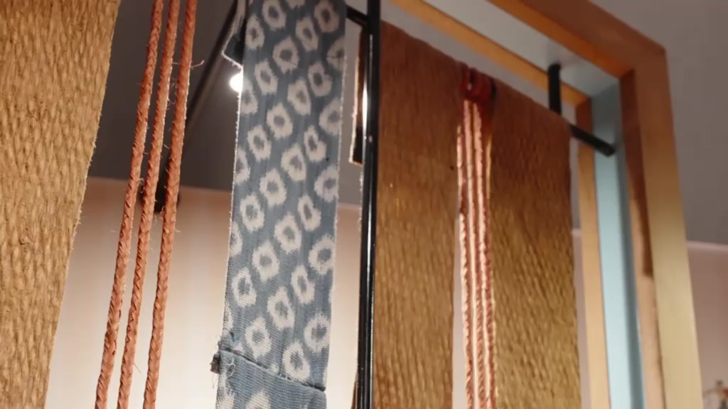 Woven Sarawak textiles hung on the screens at the launch
